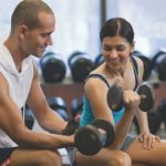 Trainer with woman working out